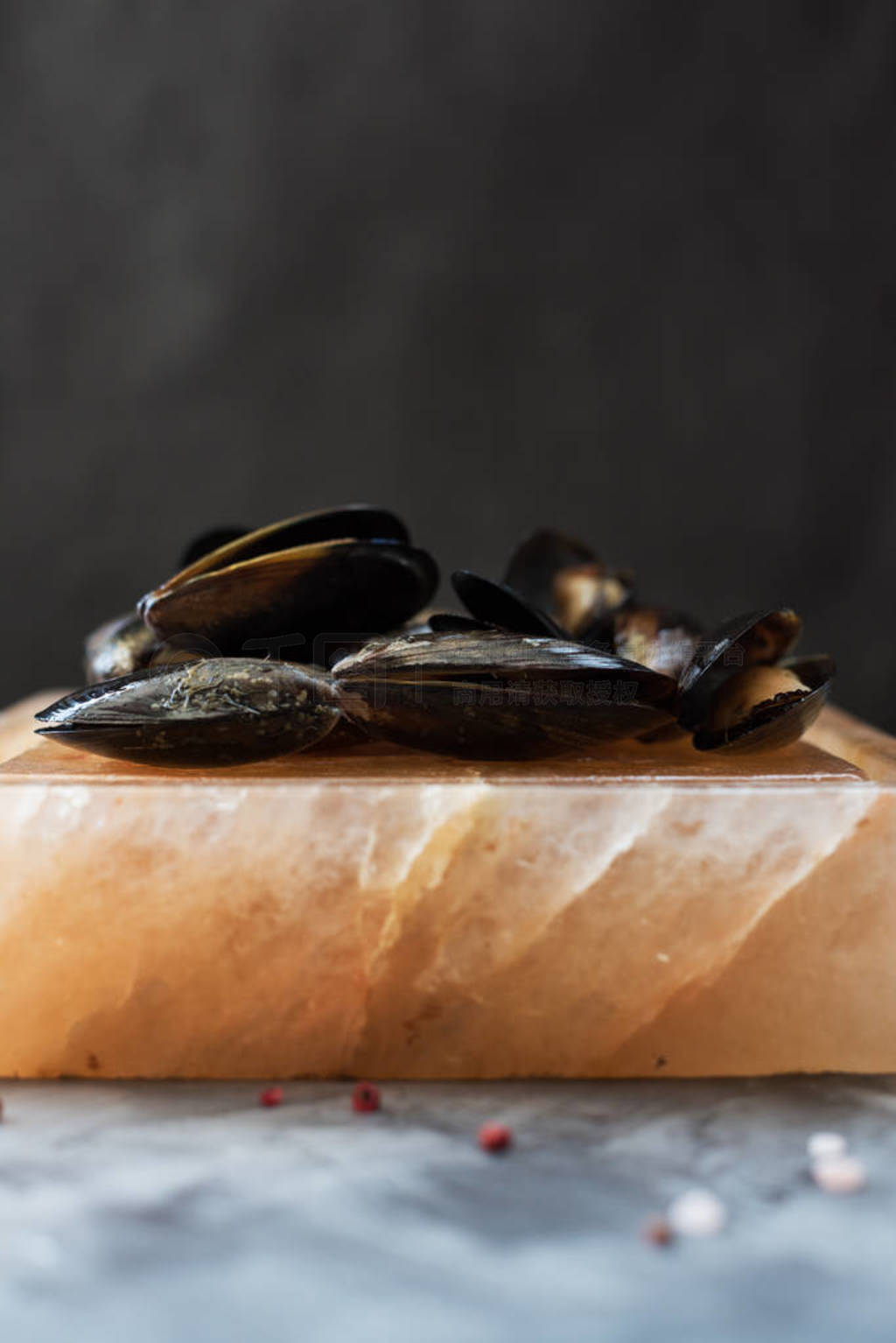 Cooking on salt block. Shellfish roasted on pink Himalayan salt