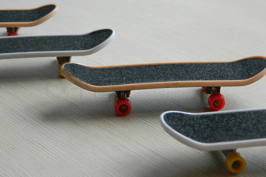 Black skateboards on gray striped surface. Skate board group of