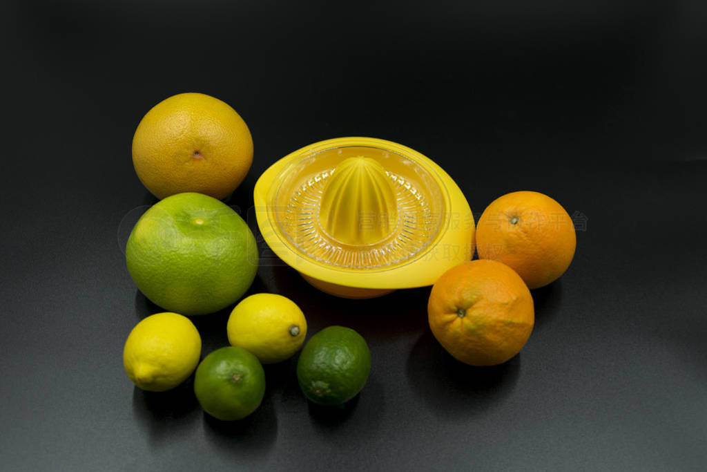 yellow citrus juicer with oranges, grapefruit, limes and lemons