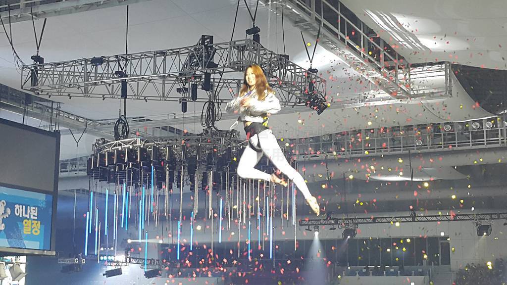 A young girl performs the acrobatic elements in the air ring dur