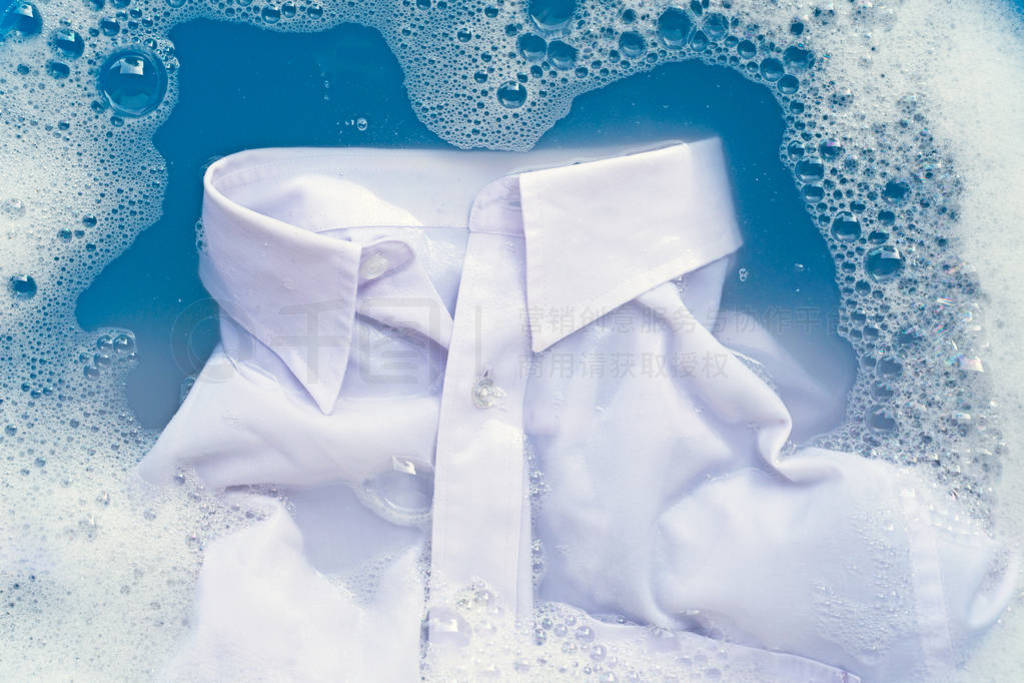 White shirt soak in powder detergent water dissolution. Laundry