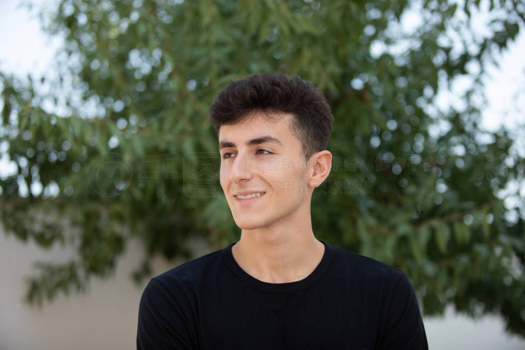 Attractive teenager guy in a park