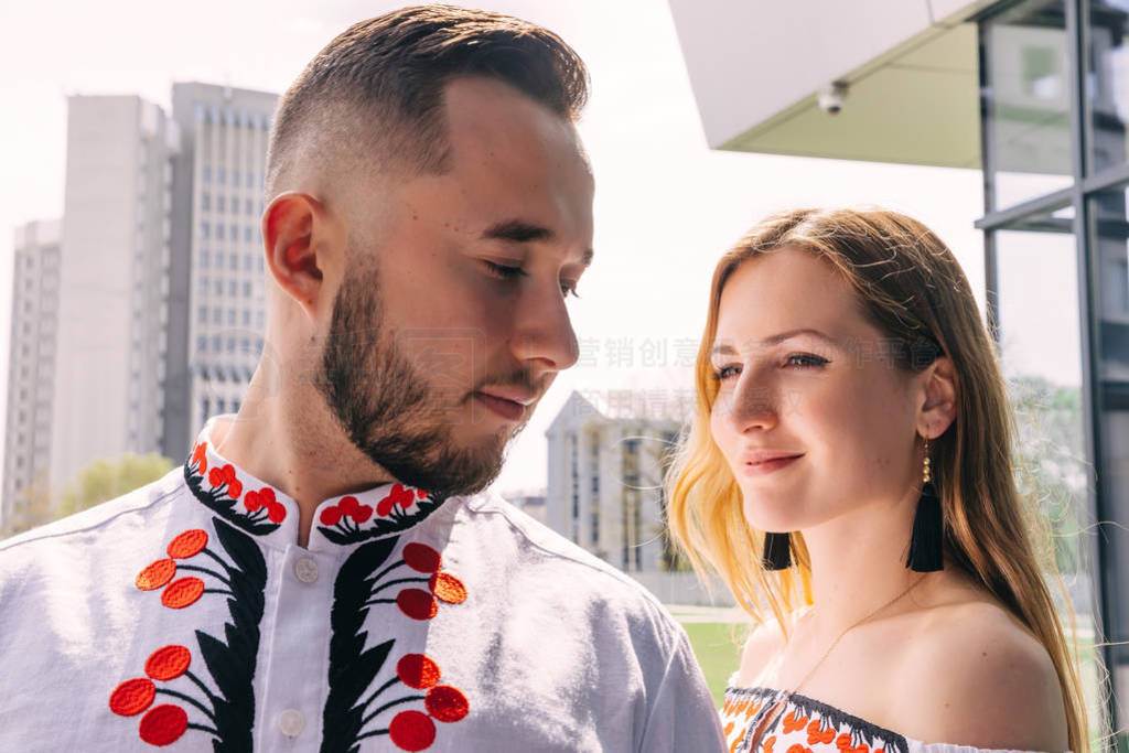 bearded guy in an embroidered shirt in the foreground. the girl