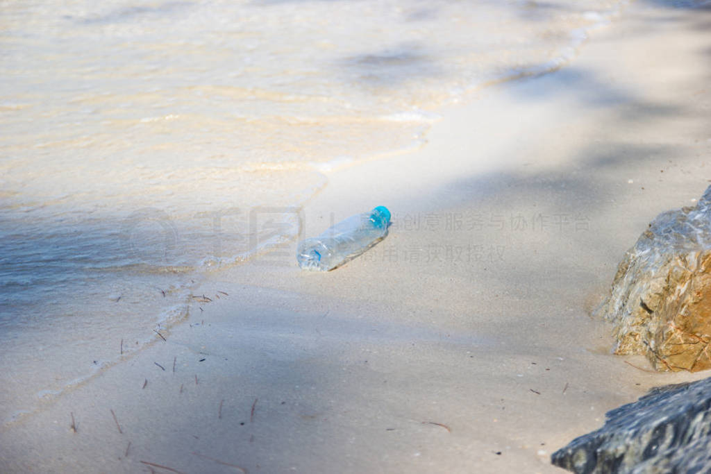 garbage and plastic bottles and dirty waste on a beach