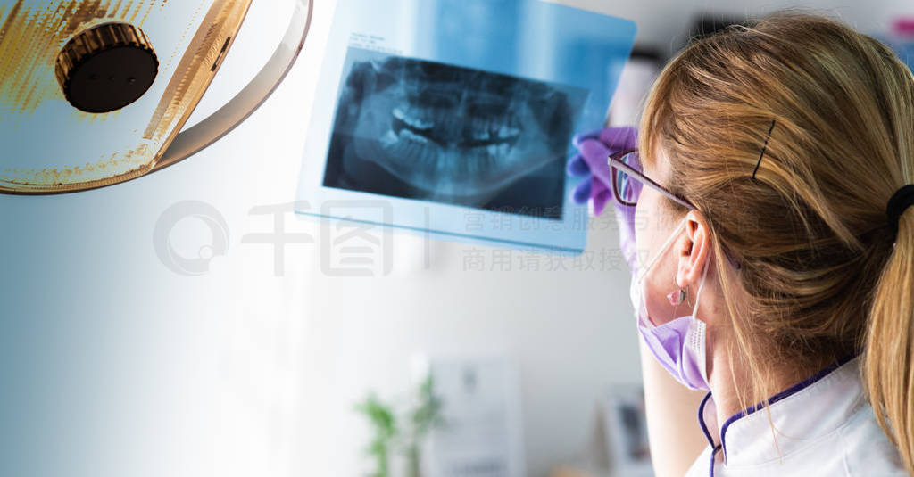 Female dentist holding x-ray image