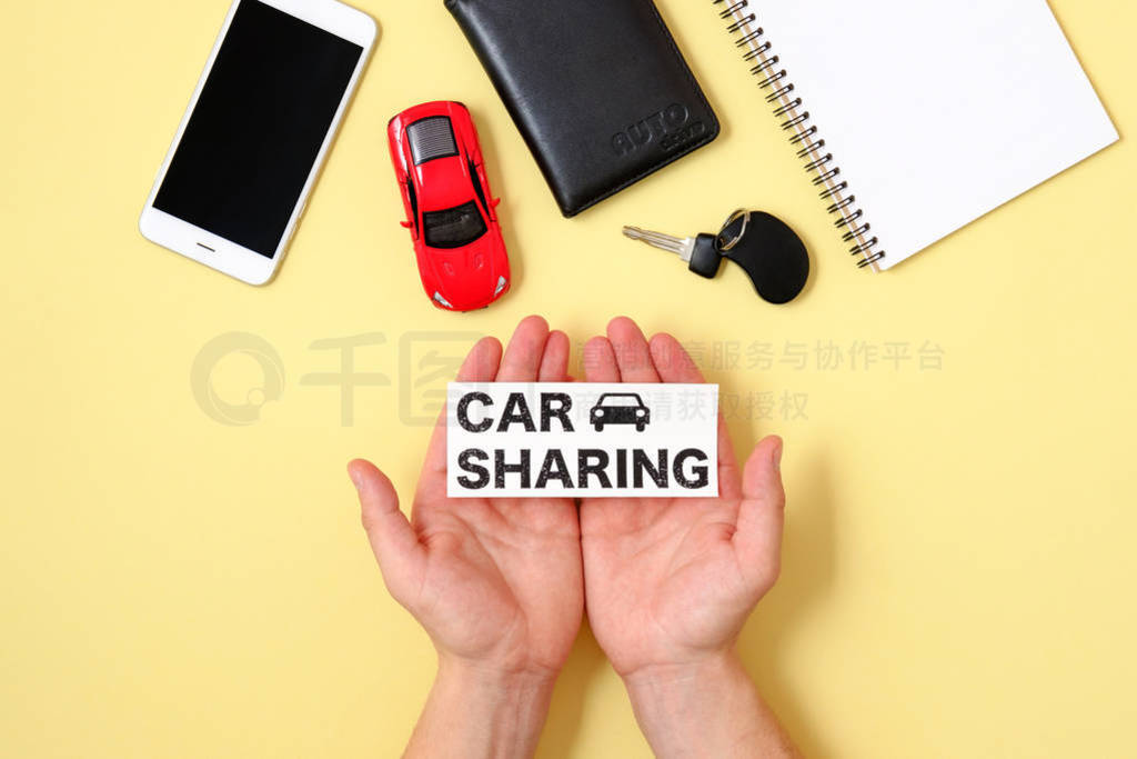 Car sharing concept. Human hands holding text sign