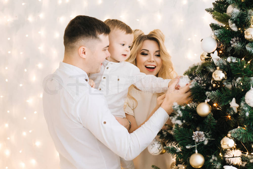 s portrait of a beautiful young family. Attractive parents and a