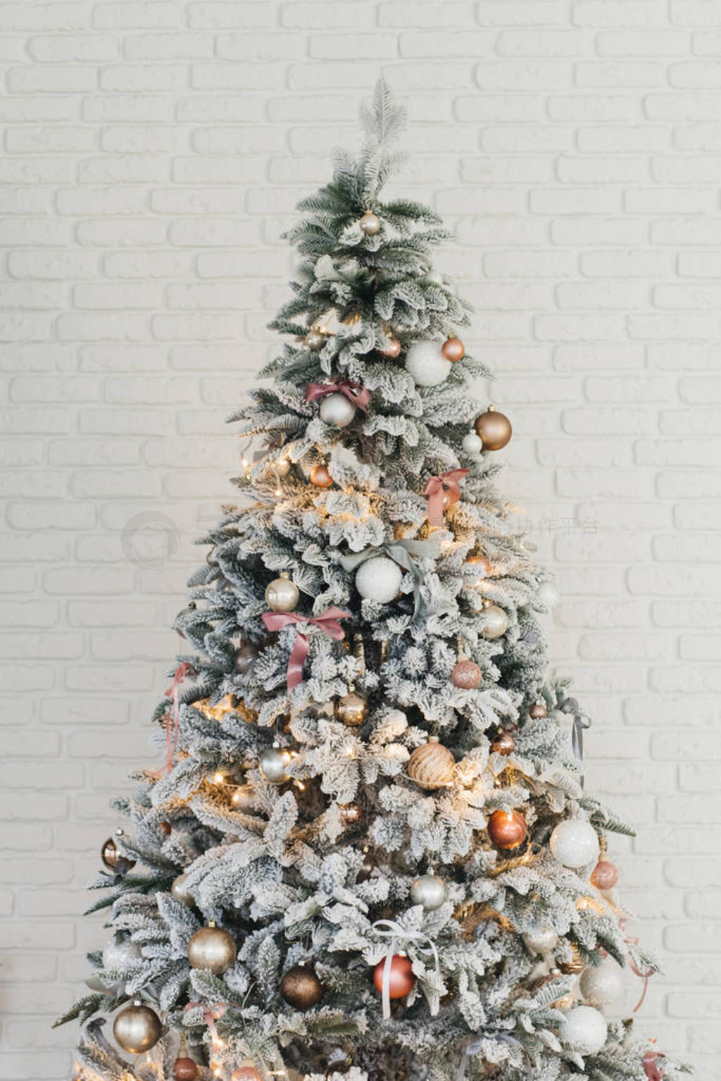 Beautiful glowing white snow-covered Christmas tree in the home