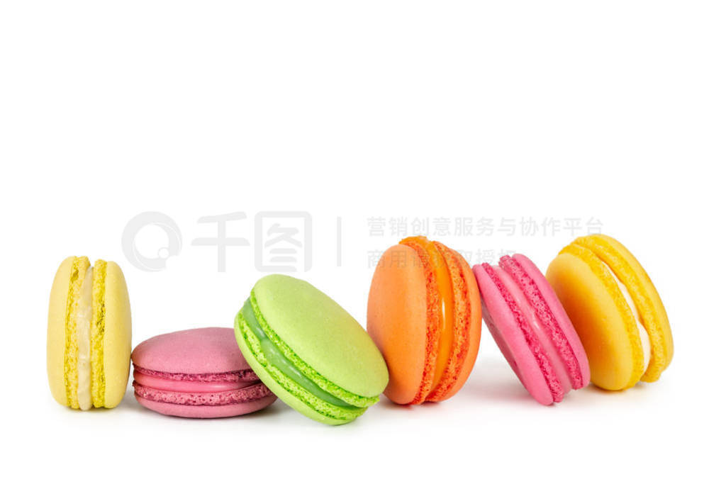 Colorful french macaroons in row isolated on white