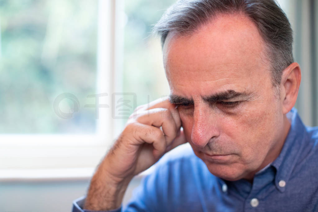 Head And Shoulders Shot Of Mature Man Suffering With Depression