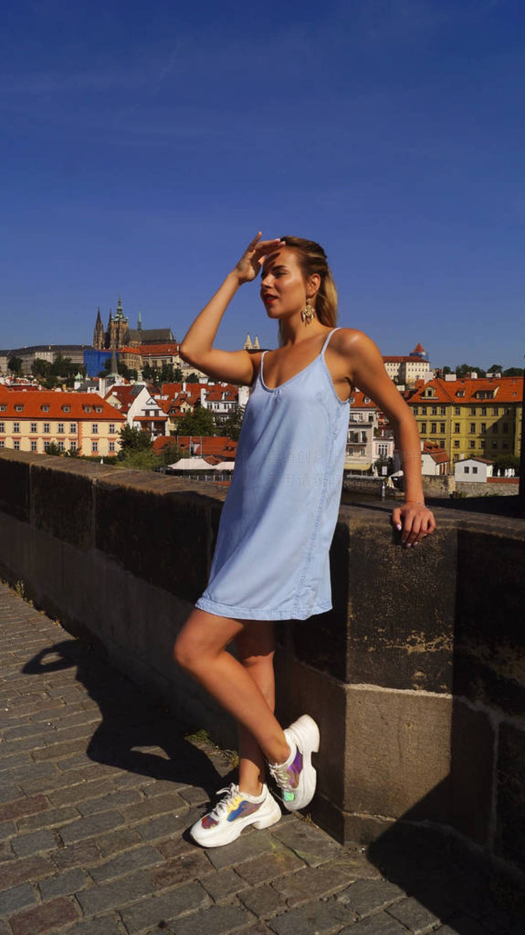 Young beautiful girl posing on the Charles Bridge