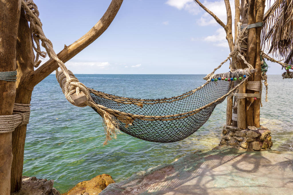 Empty hammock on beautiful tropical beach near sea water Thailan