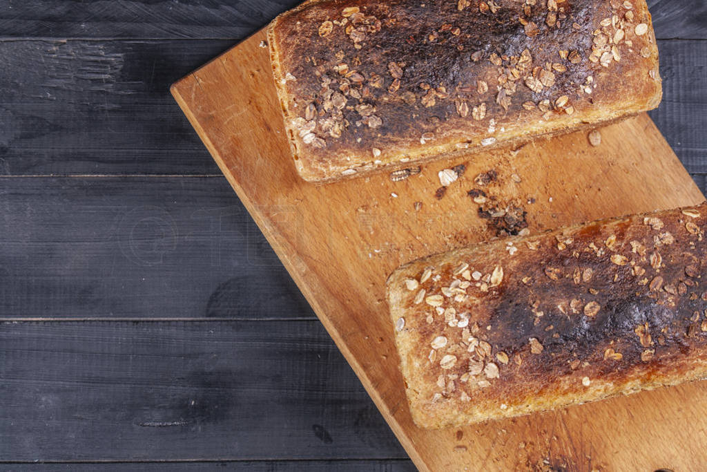 Fresh homemade cakes. Large homemade oat seed bread on a wooden