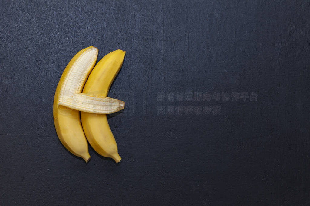 Two bananas on a chalkboard. One banana hugging the other. The t