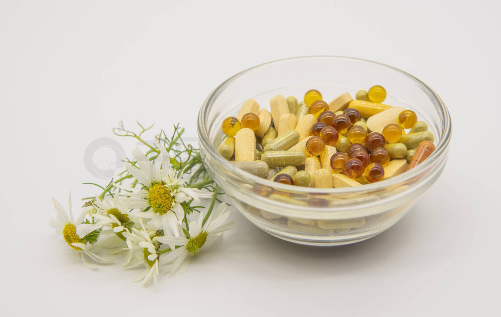 Transparent bowl with pills and tablets and a number of aromatic