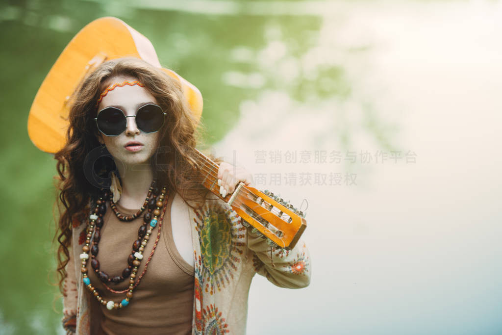 beautiful hippie with guitar