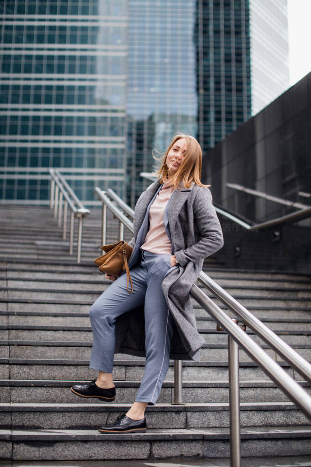 young girl in a business suit on the stairs