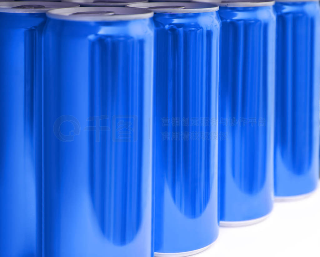 Many blank metal blue cans on table, closeup. Mock up for design