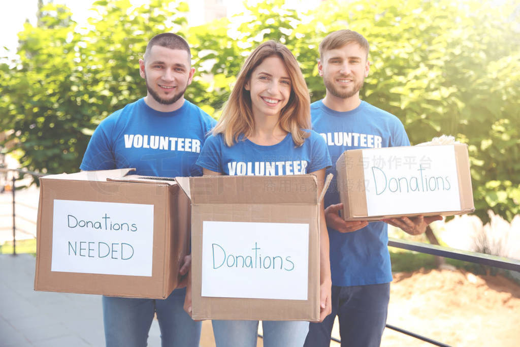 Team of volunteers with donation boxes outdoors