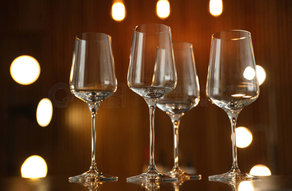 Empty wine glasses on table against blurred background