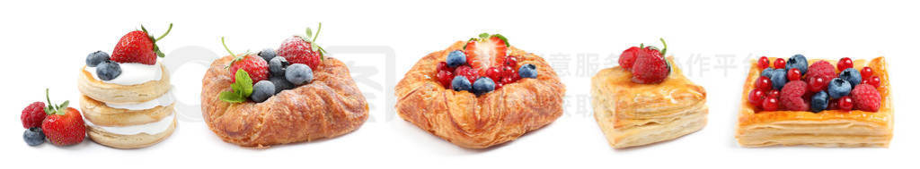 Set of fresh delicious puff pastries with sweet berries on white