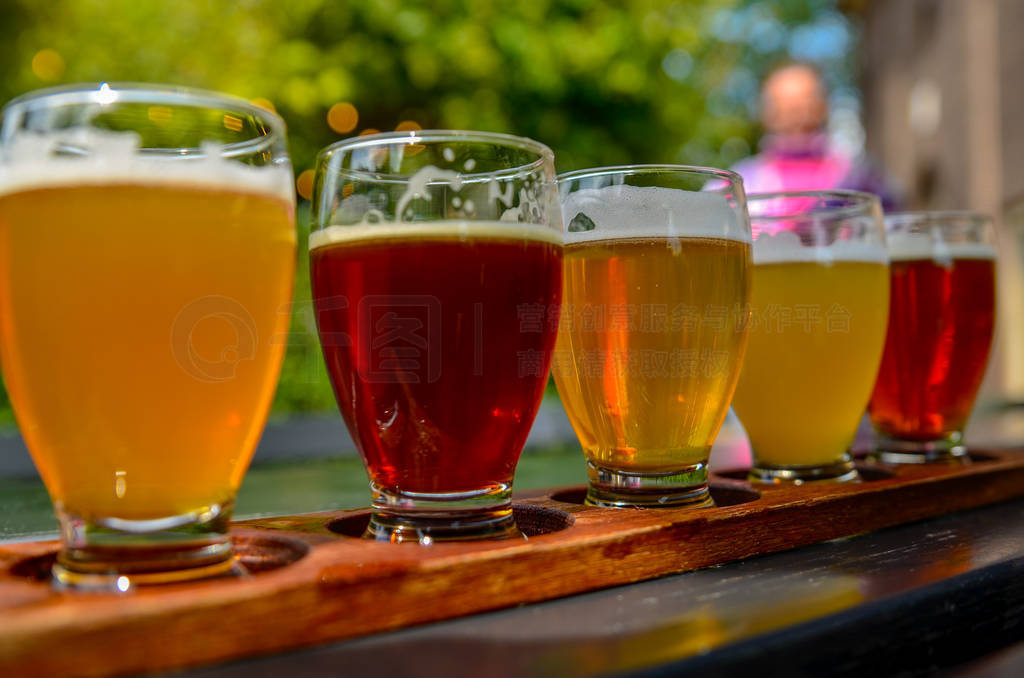 Craft beer tasting: five glasses with beers of different colors