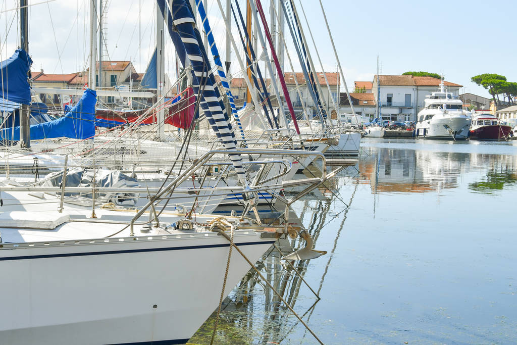 Closeup on many sailboats docked at the harbour and yachts as a