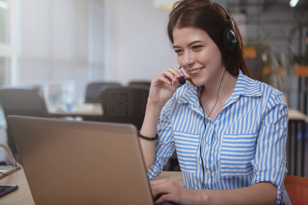Friendly customer support operator with headset working at call