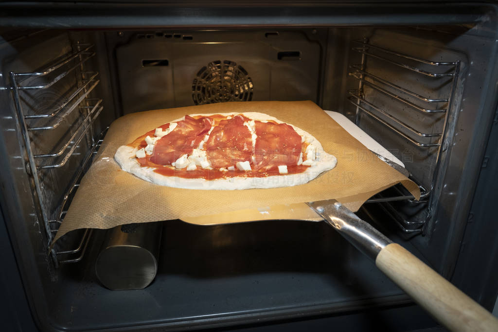 homemade pizza dough with tomato sauce and mozzarella on baking