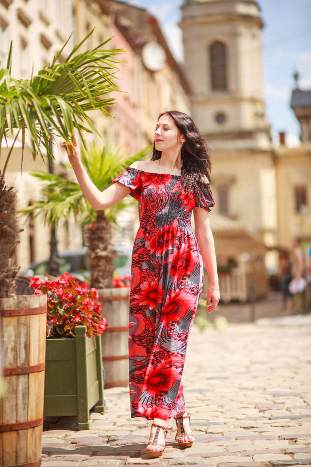 Pensive woman in long colorful dress on street of tourist old