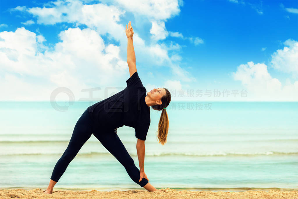 Healthy lifestyle: a girl practices yoga by the sea, performing