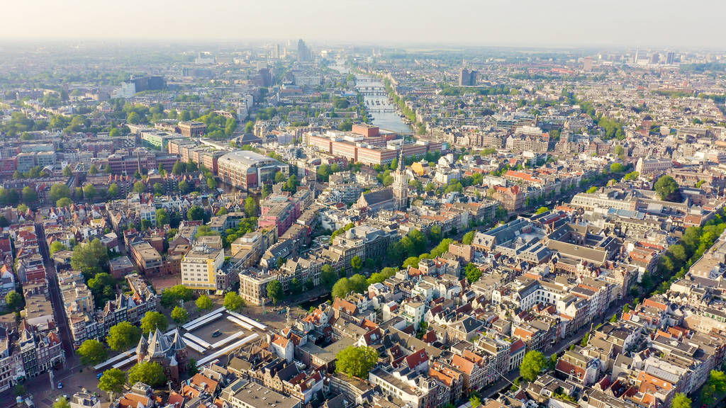 Amsterdam, Netherlands. Flying over the city rooftops towards Am