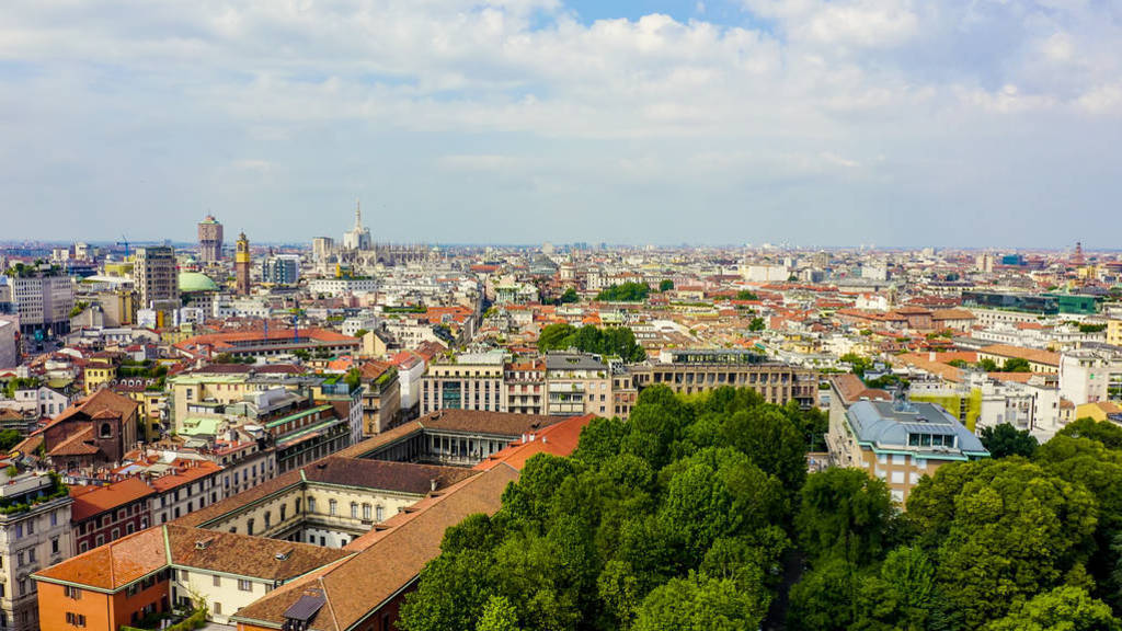 Milan, Italy. Roofs of the city aerial view. Cloudy weather, Aer