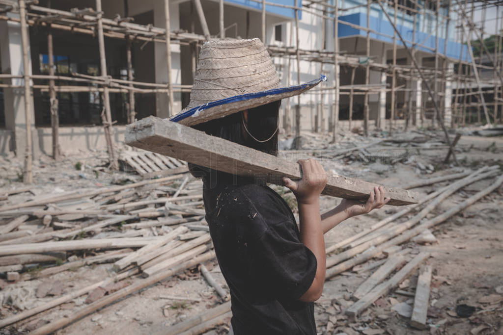 boys labor work in the construction site, Against child labor,