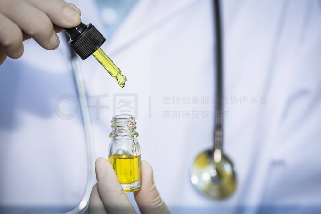 Doctors holding bottle of Cannabis oil in pipette,hemp product