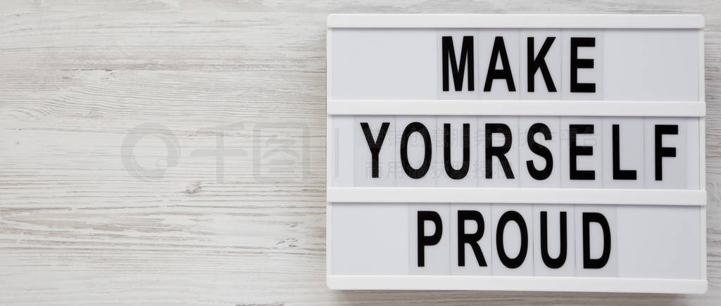 'Make yourself proud' words on a modern board on a white wooden
