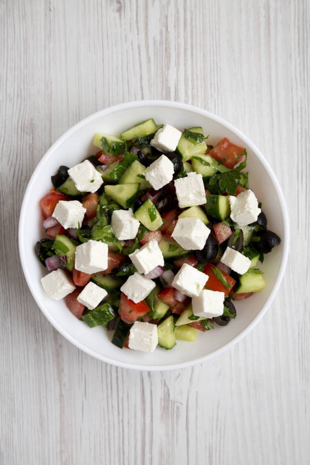 Homemade Shepherd's salad with cucumbers, feta and parsley in a