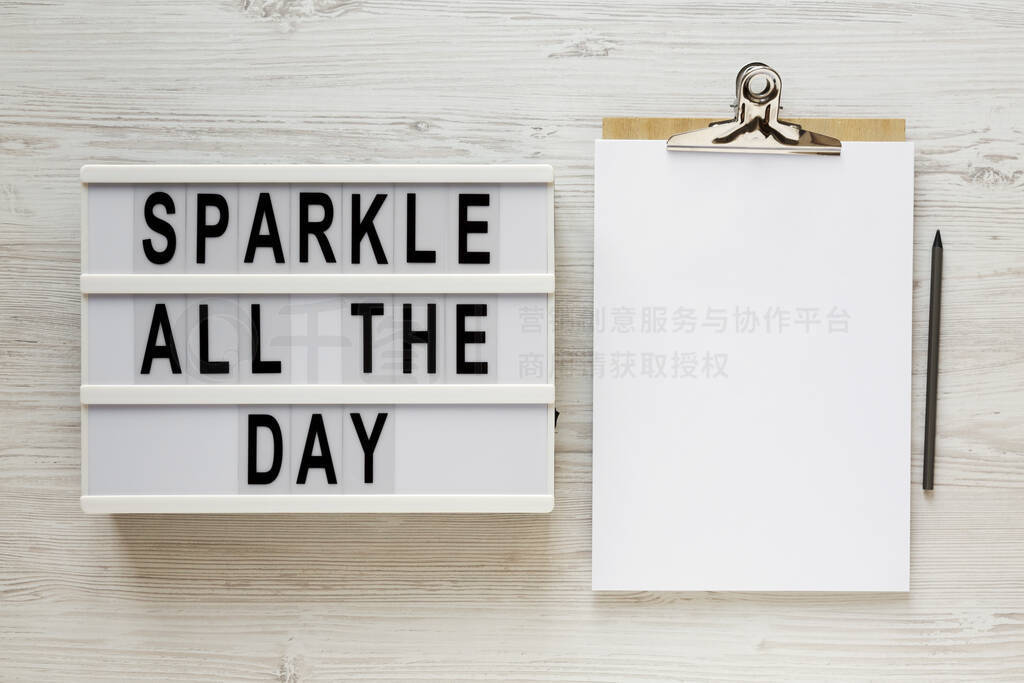 'Sparkle all the day' words on a lightbox, clipboard with blank