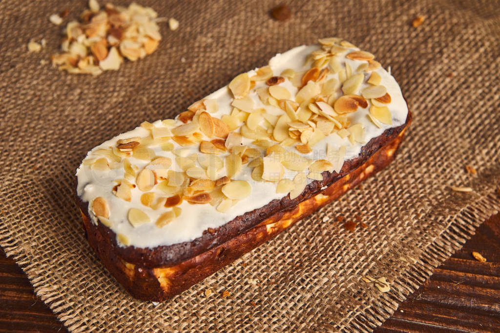 fresh classic vanilla cheesecake decorated by almond flake on wo