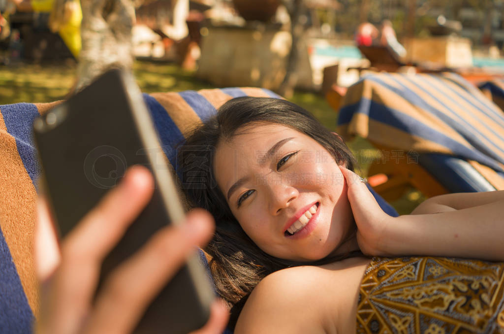 young beautiful and happy tourist Asian Korean woman taking self