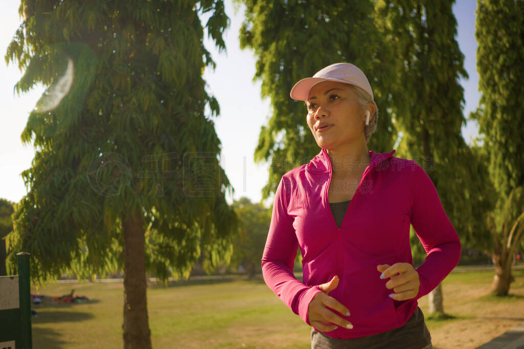 attractive middle aged woman running happy at city park . beauti