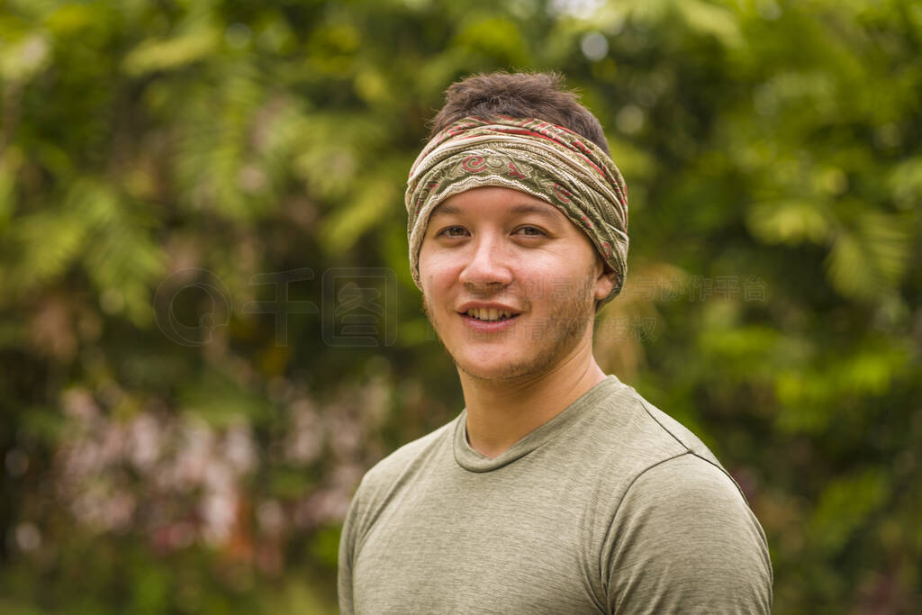 outdoors portrait of young attractive and happy hipster man enjo