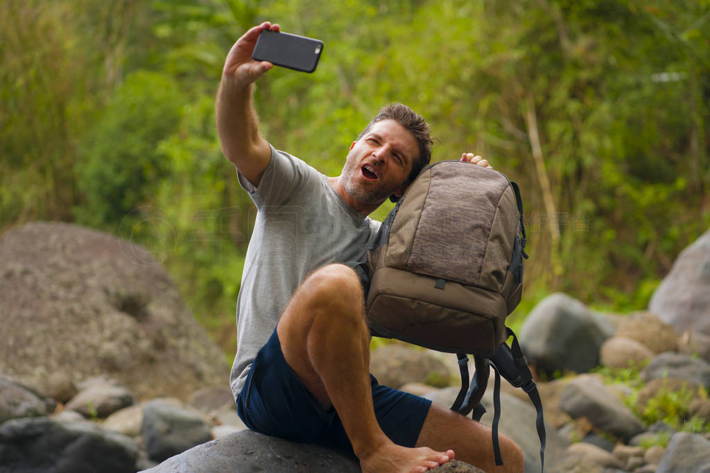 young happy and attractive man taking selfie with mobile phone h