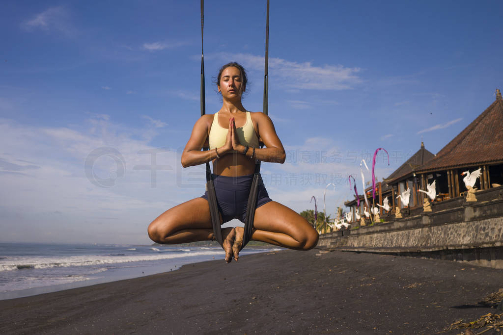 aerial yoga meditation beach workout - young attractive and heal