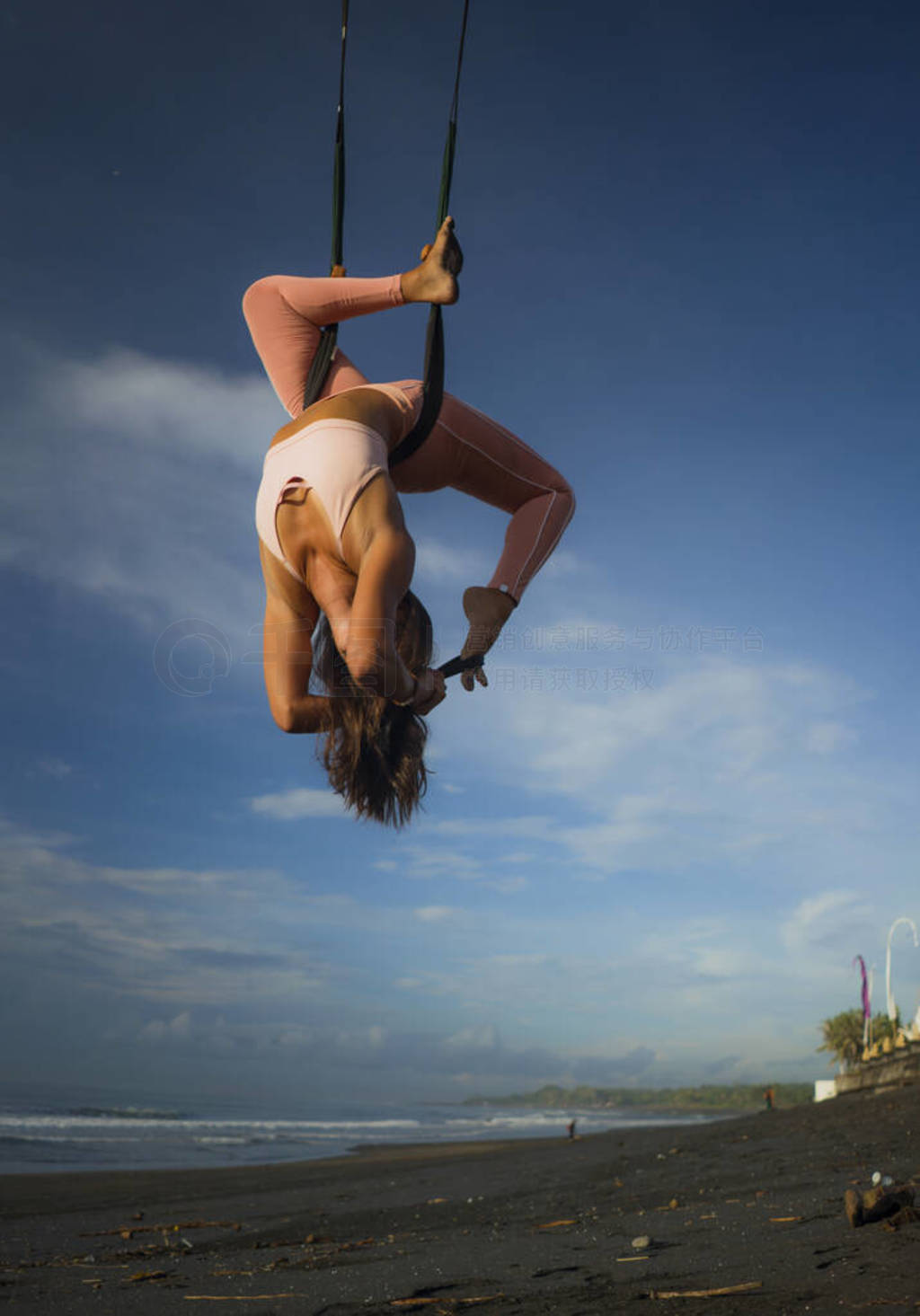 aerial yoga beach workout - young attractive and healthy woman p