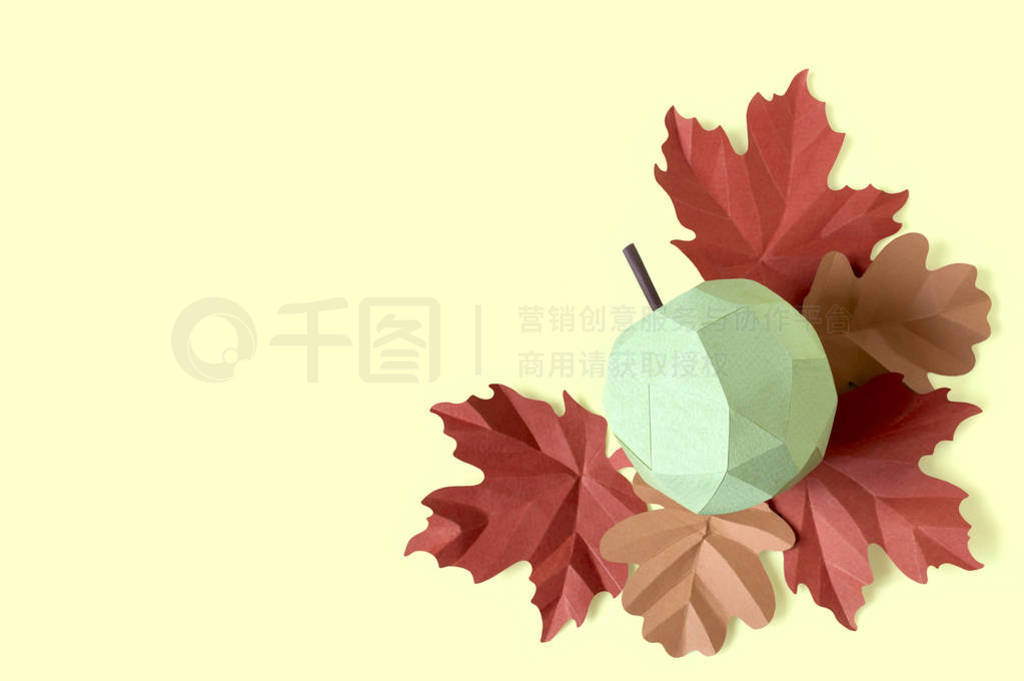 Paper apple and autumn leaves