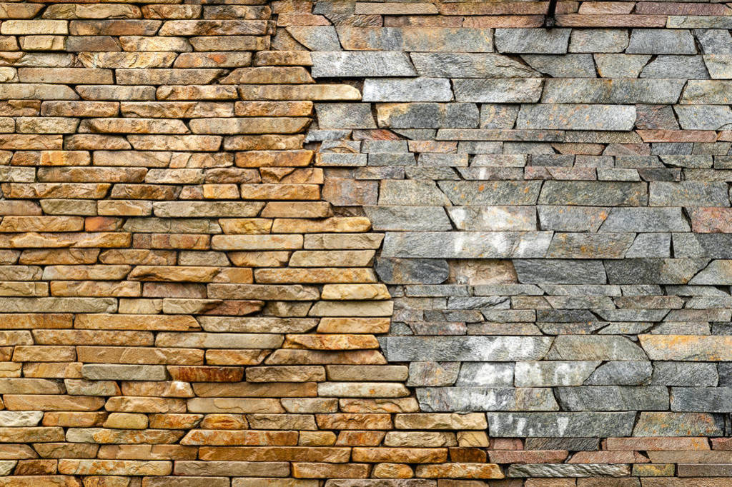 Stone wall. Masonry walls made of rough stone hewn wet discord c