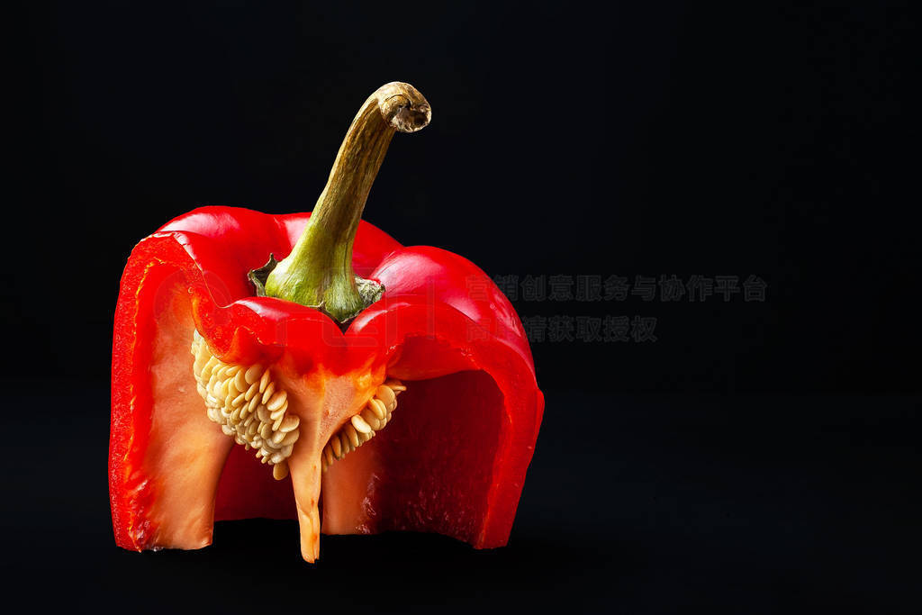 Red bell pepper with seeds. Sliced sweet pepper with pulp on a b