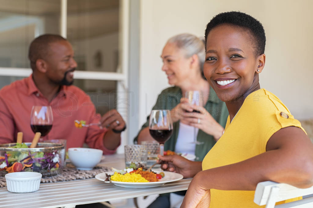 Mature woman enjoying lunch with friends