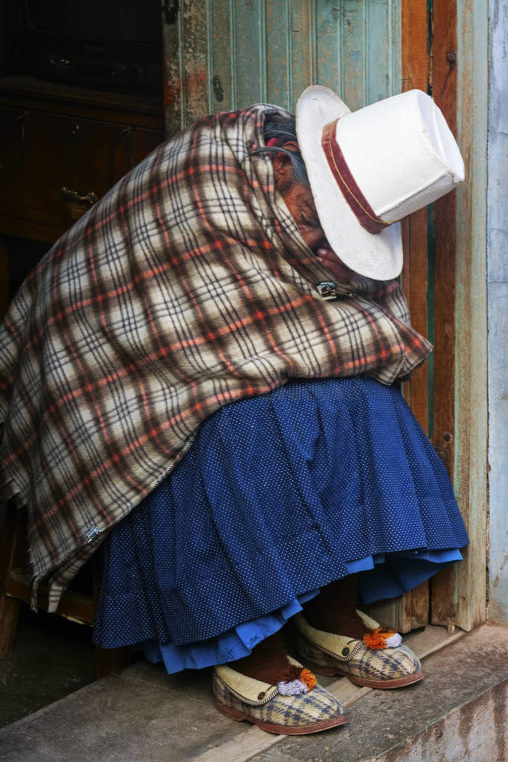 Cusco, Peru - AUGUST 31 2019: Indigenous senior woman sleeping a